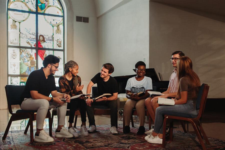 Christian Studies and Community Development students read together in a chapel.